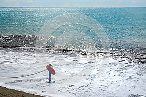 Red lifesaver on the beach - rescue concept