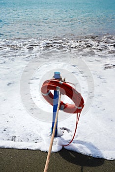 Red lifesaver on the beach - rescue concept