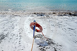 Red lifesaver on the beach - rescue concept