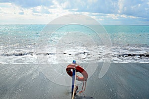 Red lifesaver on the beach - rescue concept