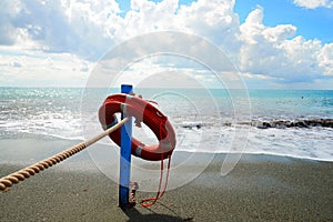 Red lifesaver on the beach - rescue concept