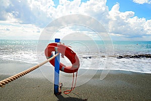 Red lifesaver on the beach - rescue concept