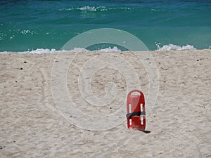 Red Lifesaver lifeguard in sand at beach