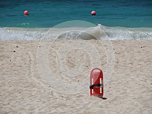 Red Lifesaver lifeguard in sand at beach