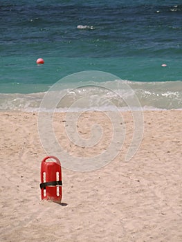 Red Lifesaver lifeguard in sand at beach