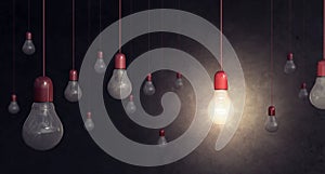 Red light bulb on dark background idea concept