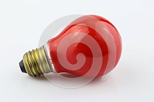 Red light bulb with yellow thread separated on white background