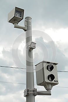 red light camera picture and video two cameras on silver post with dark clouds. p