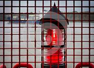 The red light of a lighthouse on the banks of the Elbe in Finkenwerder.