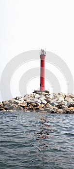 Red lighthouse as guidance for the ship to sail