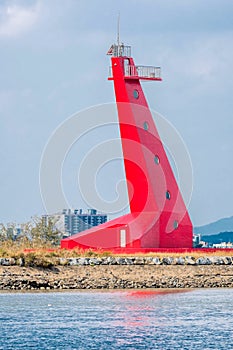 Red lighthouse on bank of estuary into Gunsan harbor