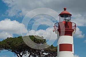 Red lighthouse on cloudy sky background in La Rochelle -  France