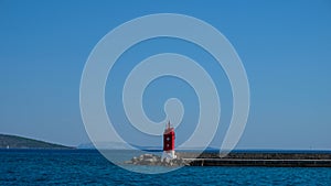 Red lighthouse in the harbor of Krk