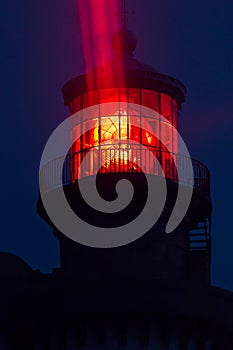 Red lighthouse illuminated