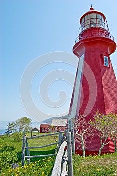 Red lighthouse at La Martre with fence photo