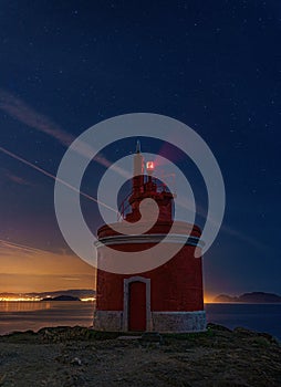 RED LIGHTHOUSE AT NIGHT IN CABO HOME, CANGAS, SPAIN