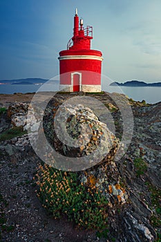 RED LIGHTHOUSE AT NIGHT IN CABO HOME, CANGAS, SPAIN