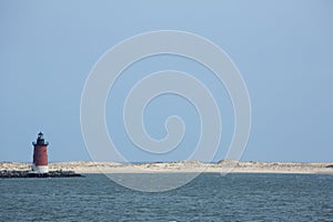 Red lighthouse and sand dunes near Cape Henlopen, Delaware. photo