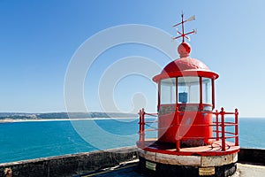 Red lighthouse on the Sao Miguel fort in NazarÃ©, Portugal