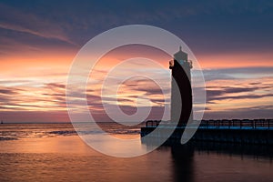 Red lighthouse at sun rise on Lake Michigan in Milwaukee