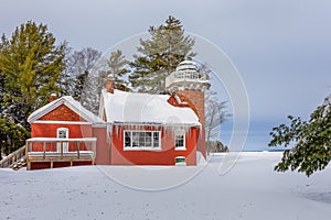 Red Lighthouse Under Deep Snow