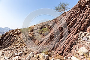 Red limestone and dolomite rock formations in Hajar Mountains on Arabian Peninsula, United Arab Emirates, Hatta