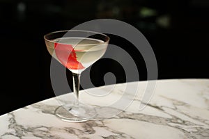Red line cocktail glass on a marble bar counter
