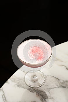 Red line cocktail glass on a marble bar counter