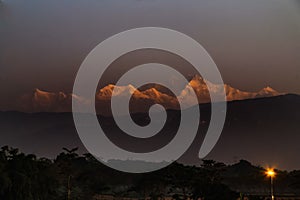 The red line of the sunset with the black clouds and the mountains of clouds