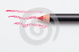 Red lip liner on white background. Close-up. Beauty concept