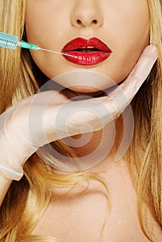 Red lips with Botox syringe