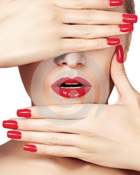 Red lips and bright manicured nails. open mouth. Beautiful manicure and makeup. Celebrate make up and clean skin