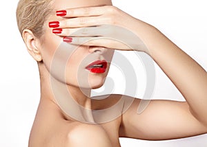 Red lips and bright manicured nails. open mouth. Beautiful manicure and makeup. Celebrate make up and clean skin