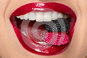 Red Lips With Glitter Lipstick And Candy In White Teeth