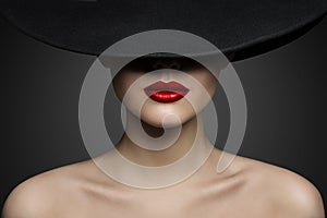 Red Lips Make up Closeup. Mysterious Fashion Woman Face Hidden by Black brimmed Hat. Elegant Retro Lady Fine Art Portrait