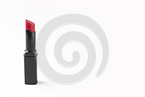 Red lipstick in a black tube isolated on a white background. Beauty and lip care, cosmetics.