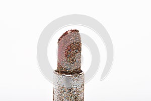 Red lipstick with glitters isolated on white background.