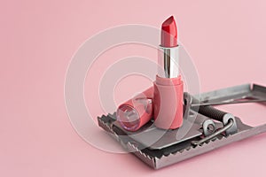 Red lipstick in rat trap on pink background copy space. Online internet romance scam or swindler in website application dating