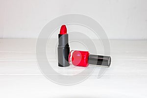 Red lipstick and red nail polish isolated on white background with copy space