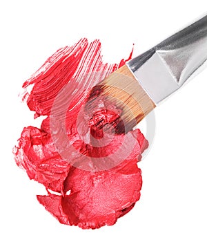 Red lipstick sample with makeup brushon whit