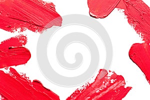 Red lipstick smears on white background, top view.