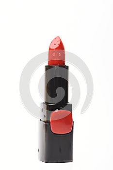 Red lipstick with water droplets, isolated on white background.