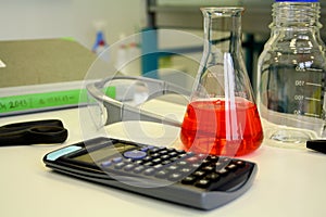 Red liquid in beaker on the table in laboratory