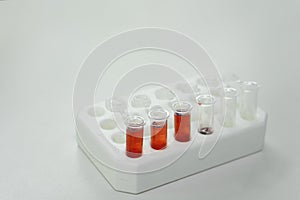 Red liquid in different individual containers on a microtiter plate