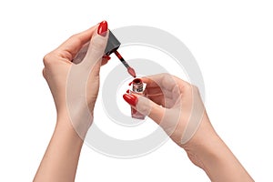 Red liquid lipstick in woman hands with red nails  on a white background