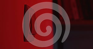 Red lit light switch on a wall close up