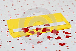 Red little hearts coming out from yellow envelope on valentine day background with copy space, loveletter concept