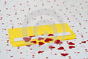 Red little hearts coming out from yellow envelope on valentine day background with copy space, loveletter concept