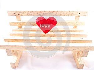 Only red little pillow with love word on beige empty wooden chair