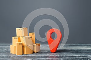 Red location pointer geolocation symbol and cardboard boxes. Distribution delivery of goods, freight transportation shipment.